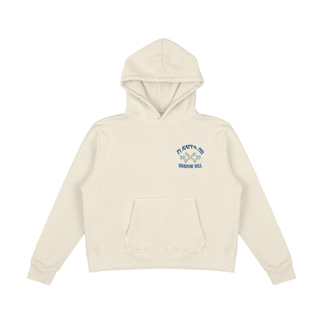 Front of cream Pi Kappa Phi hoodie with kangaroo pocket and blue Shadow Hill logo on chest.