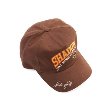 Brown Shadow Hill Sunday Rally cap with red and yellow embroidery and a white signature on the brim